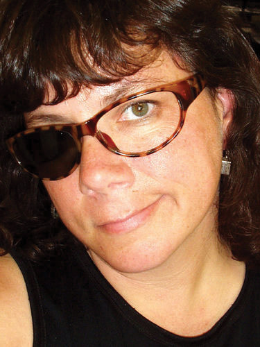 A woman wearing a pair of sunglasses with one lens missing